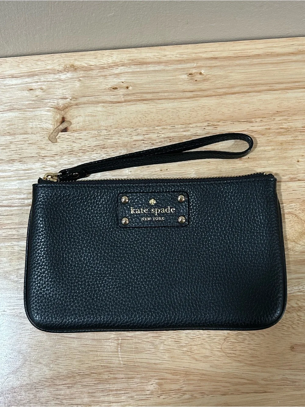kate spade black pebbled leather wristlet with gold-tone logo